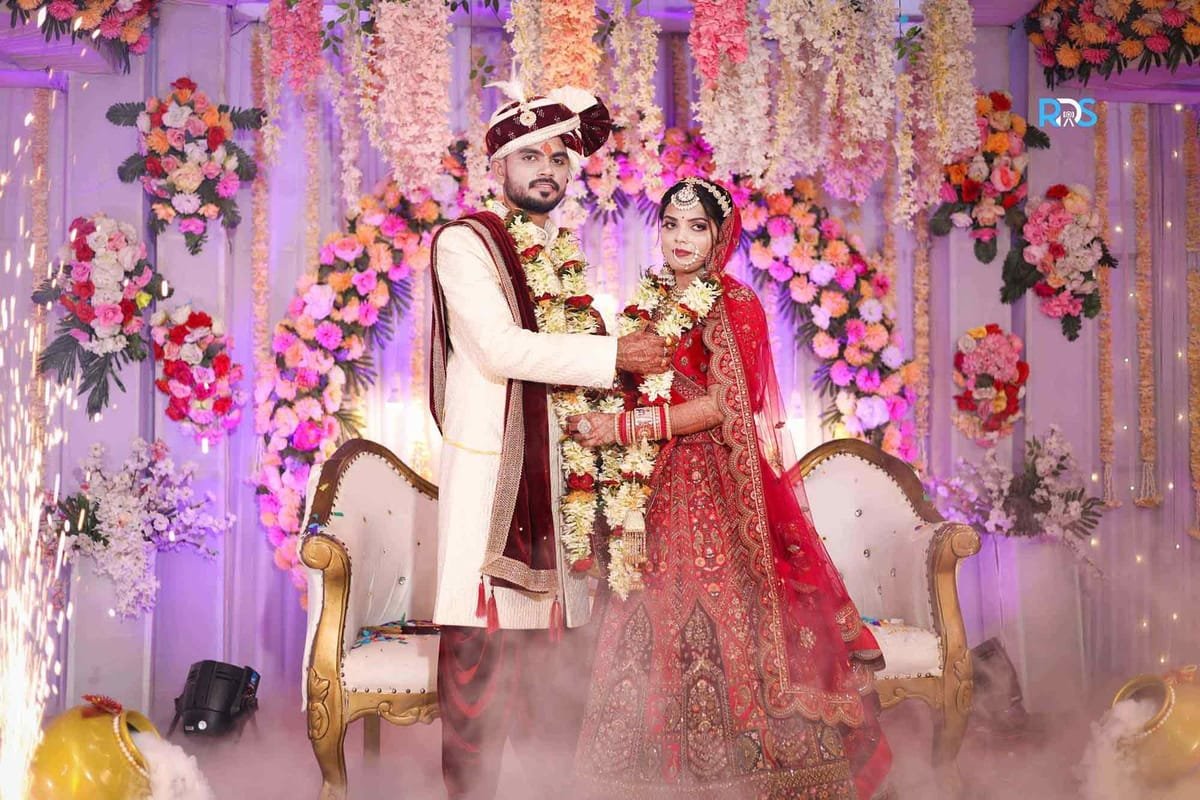 Varmala ceremony under floral decorations